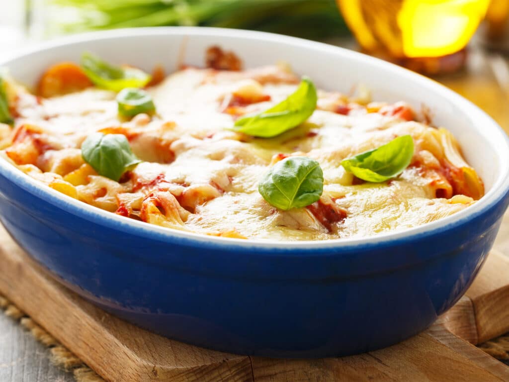 Fresh meatless italian pasta bake with vegetables and basil.