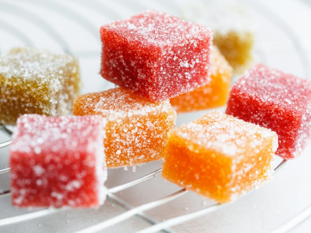 Fruit cube jelly candy on cake rack