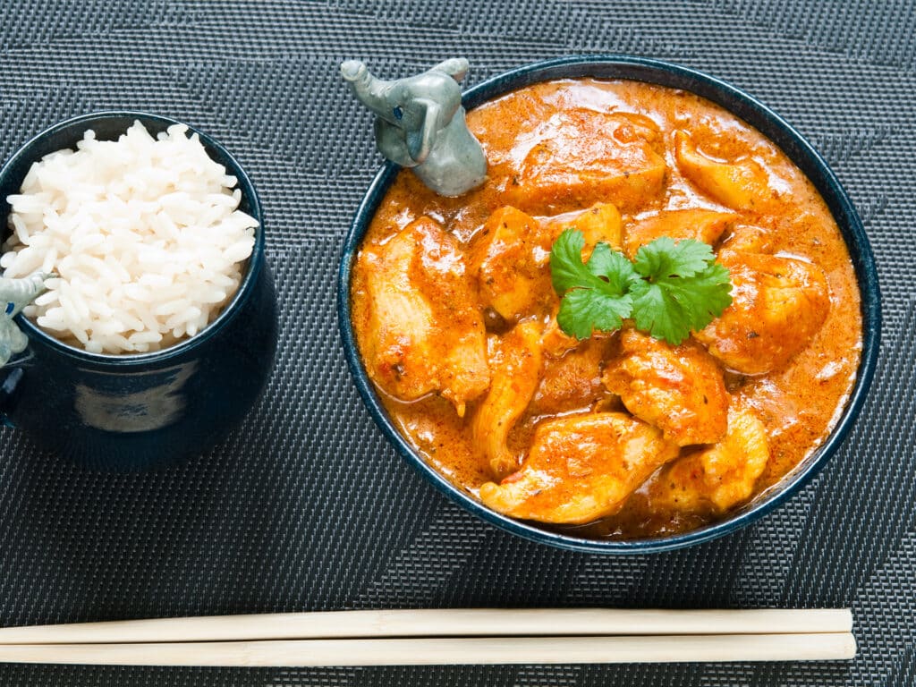 Chicken curry with rice and chopsticks