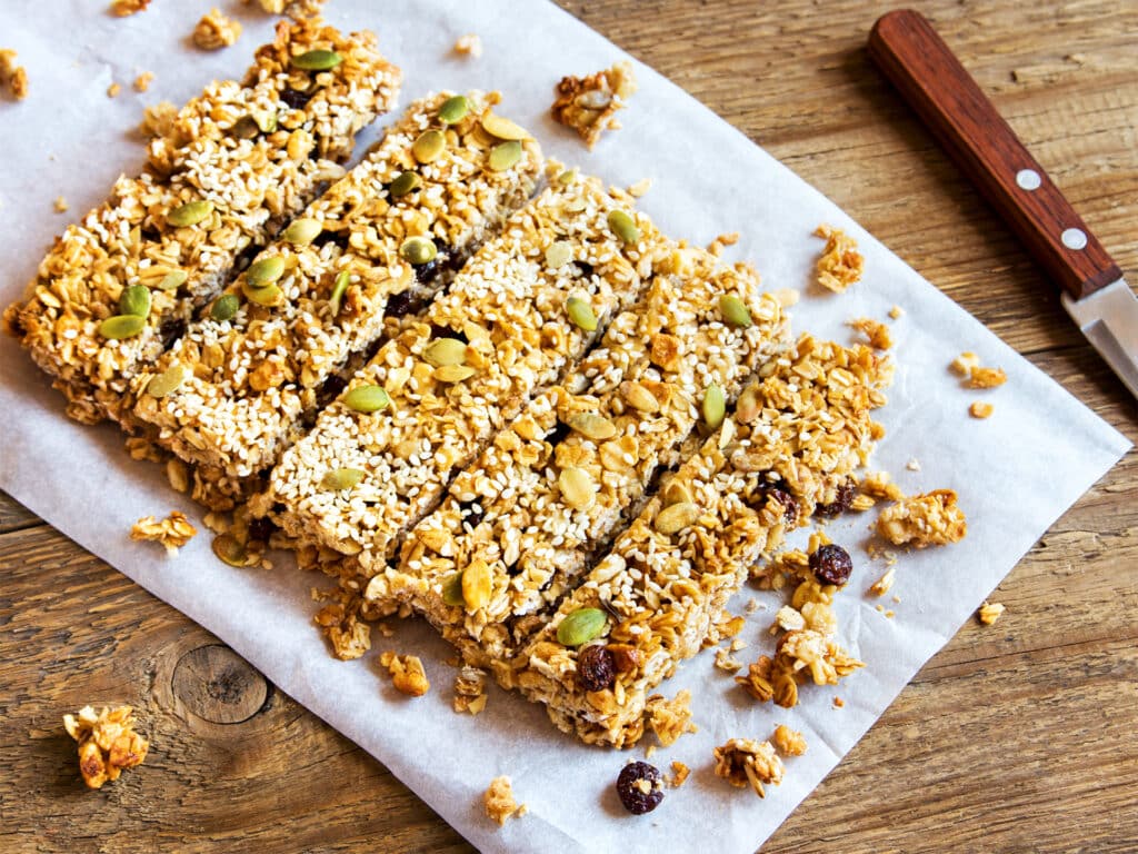 Organic homemade granola bars on rustic wooden background - Healthy vegetarian snack