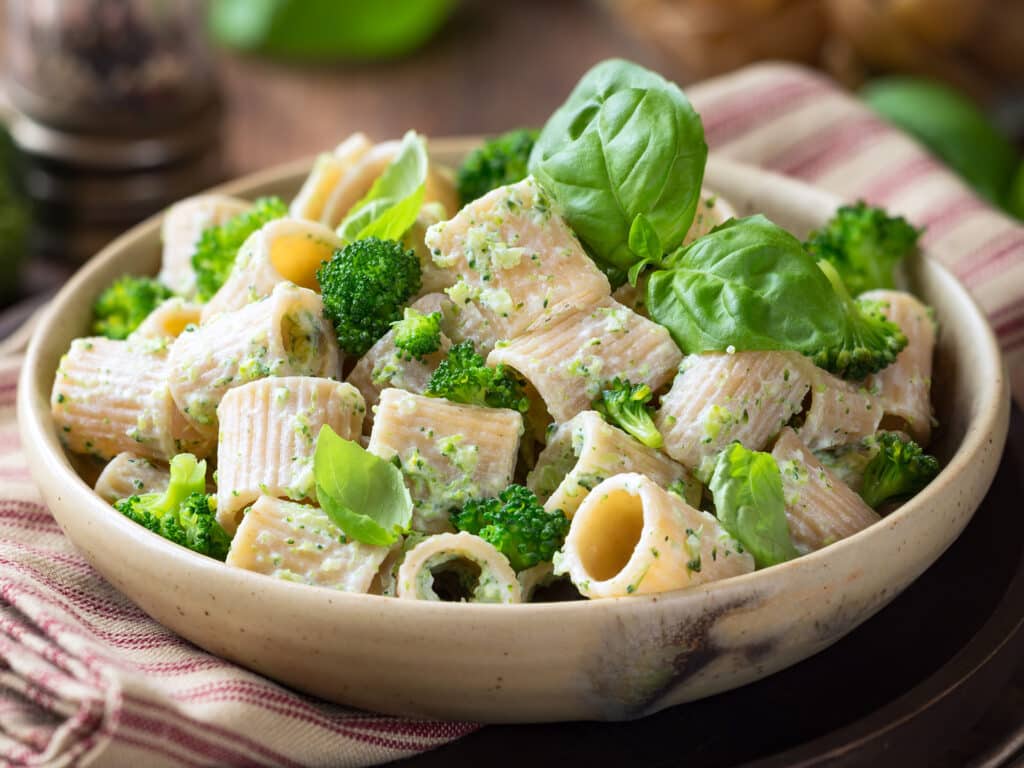 Vegetarian whole grain pasta with creamy broccoli sauce and basil