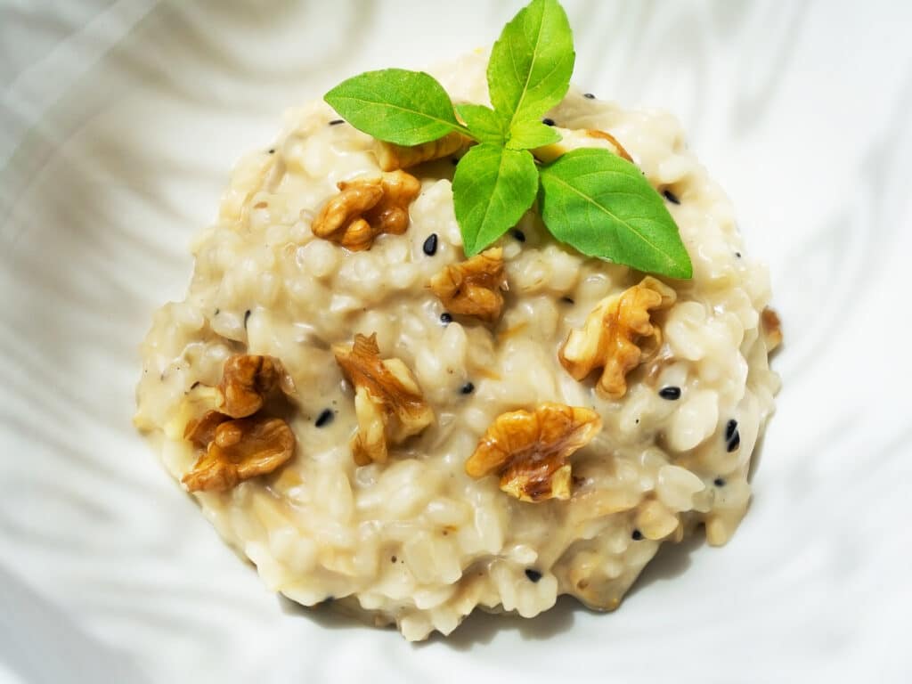 Risotto with nuts and basil leaves.